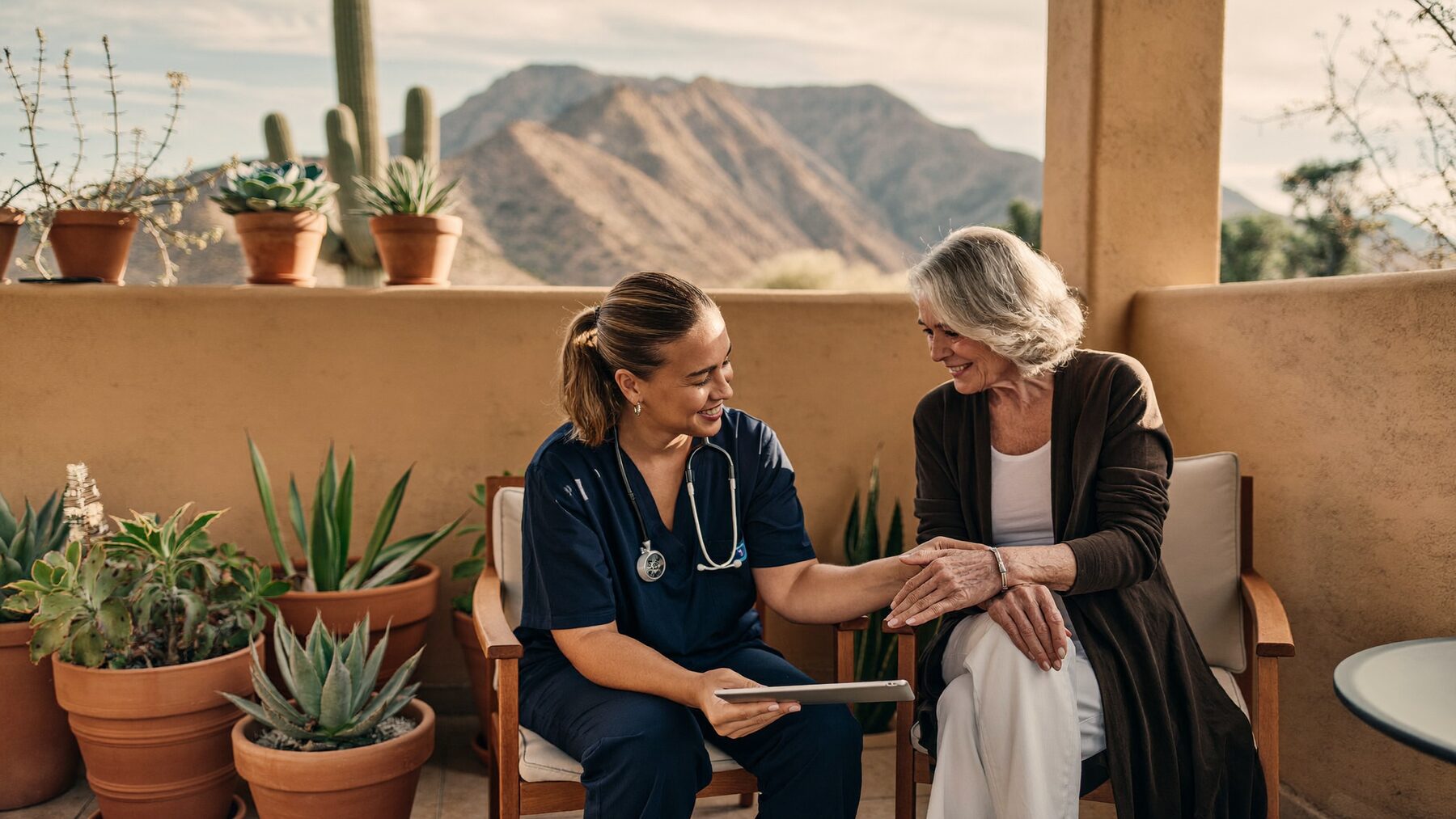Nurse practitioner reviewing a wound care plan with an older patient on a shaded Arizona patio.